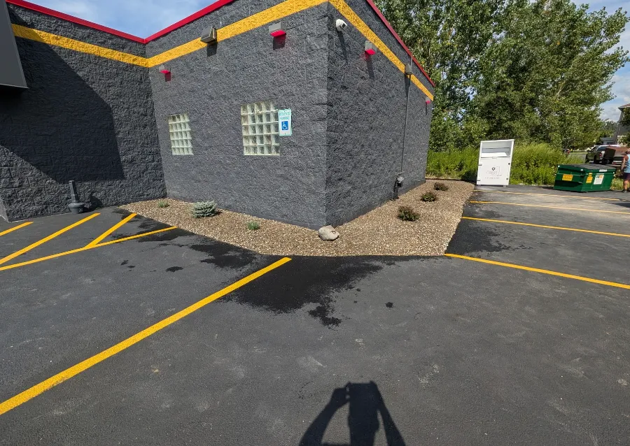 Commercial landscape installation with decorative stone and new shrubs