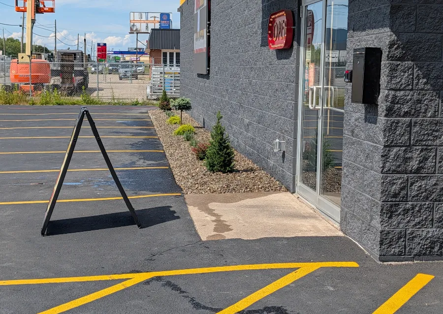 Stone and shrub plantings at a commercial building entrance