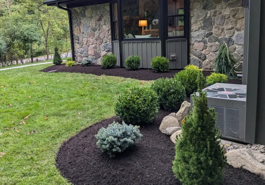 Manicured shrubs, stone edging and clean beds in Orchard Park, NY