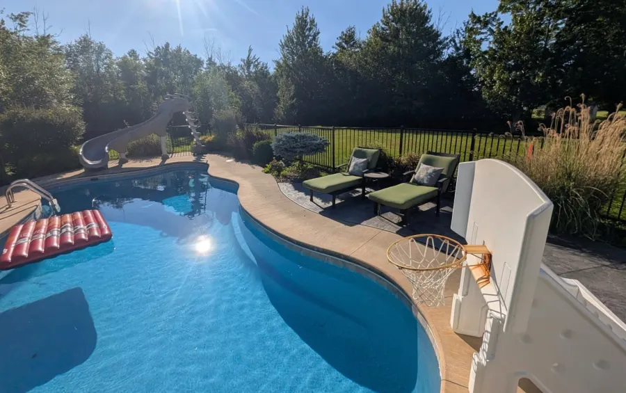 Trimmed shrubs and clean mulch beds around a backyard pool
