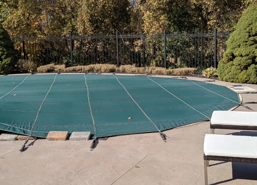 The same poolside bed after a fall cleanup with the grasses cut back